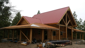 completed log home kit with red roof